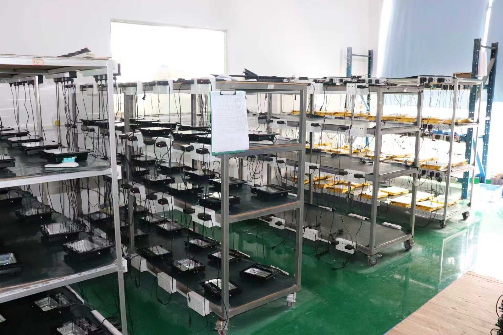 Lighting products on burn-in testing racks in the Shengjia factory.