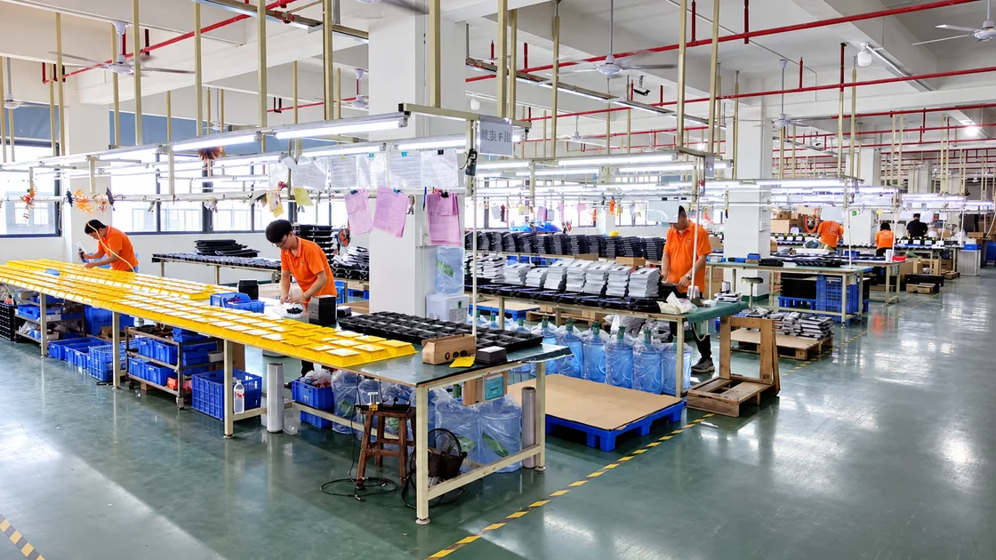 Shengjia Lighting staff assembling lighting products across the factory production workstations.